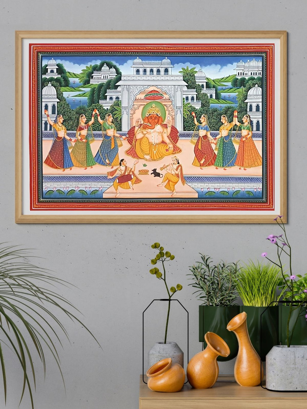 framed painting of lord ganesha on a wall